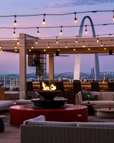 A rooftop gathering space overlooking the Gateway Arch